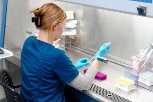 scientist using testing equipment
