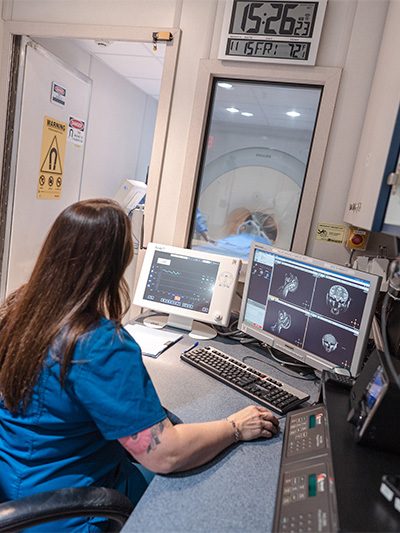 technician looking at mri scans